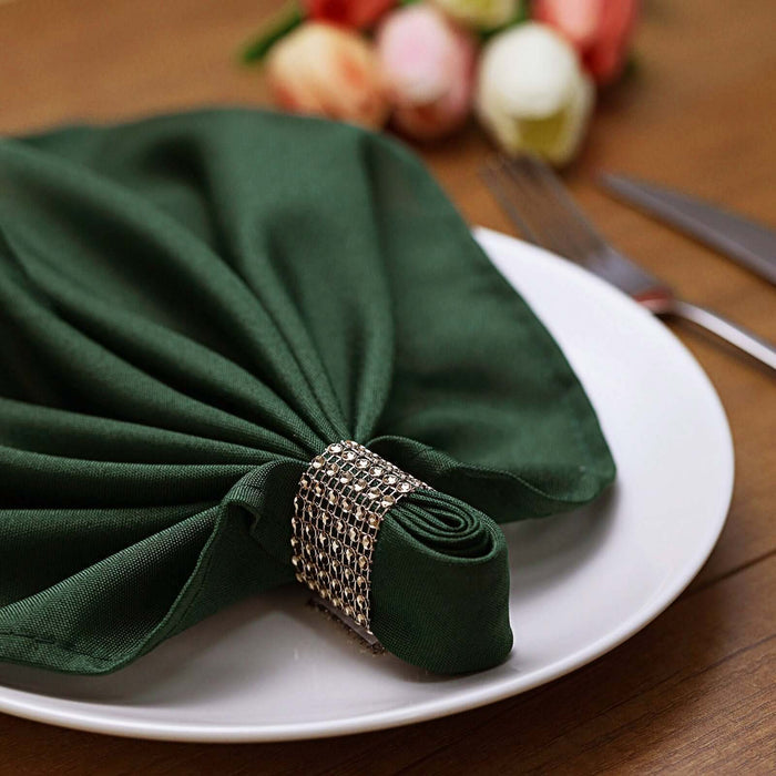 Green napkin elegantly styled on a white plate with a decorative ring.