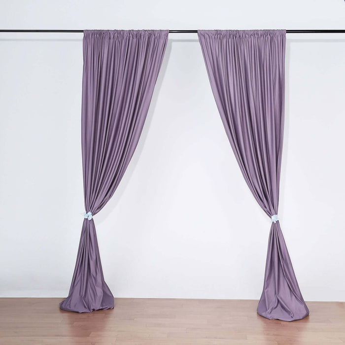 Purple curtain panels draped on a rod in a studio setting.
