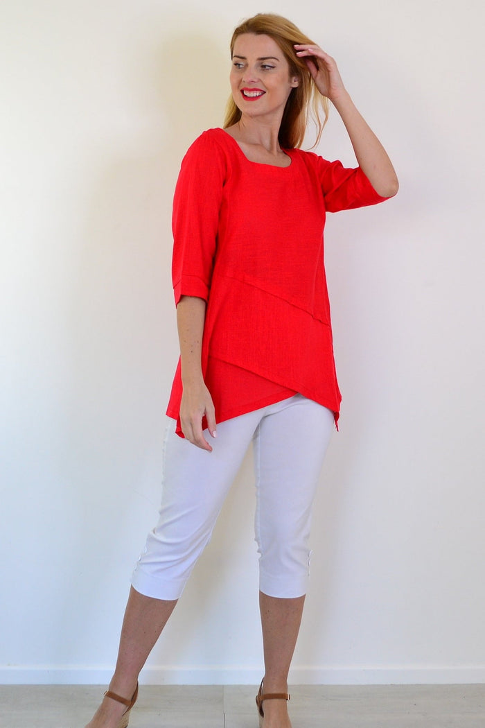 Candy apple-colored layered linen blend tunic top by Ruby Rain, featuring a relaxed fit and lightweight fabric, displayed on a hanger.