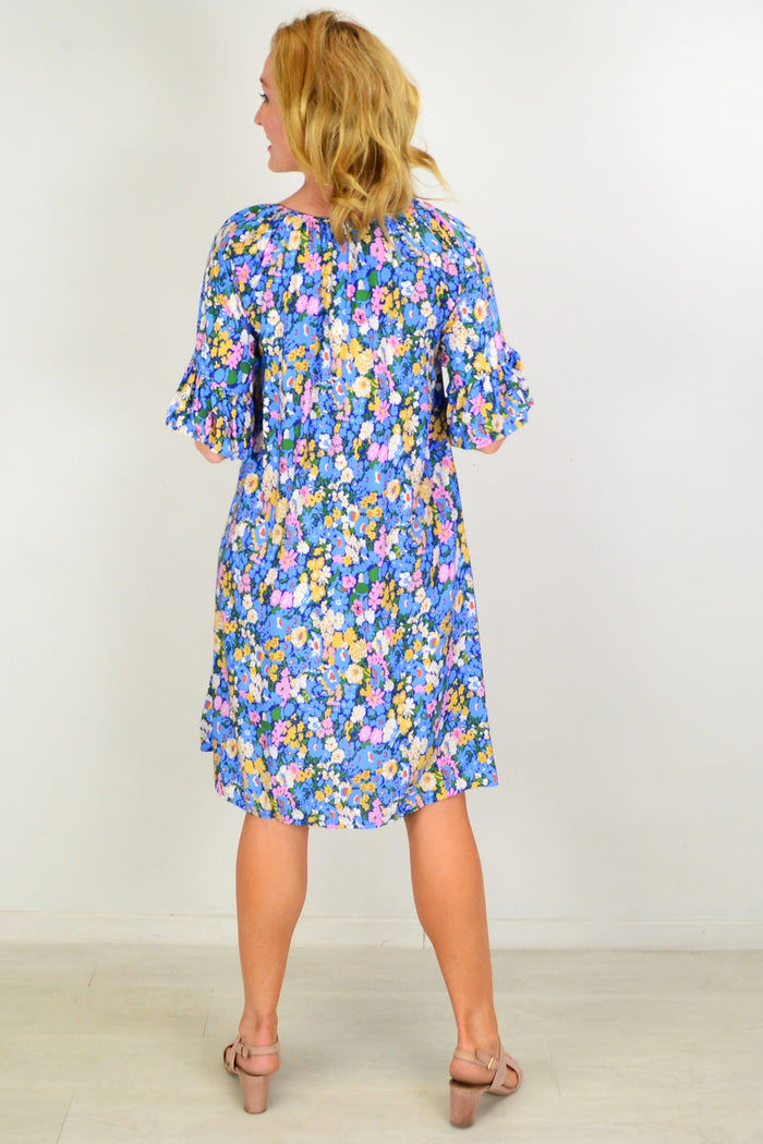 Hourglass Fairy Garden shift tunic dress with floral patterns, lightweight fabric, and relaxed fit displayed on a hanger.