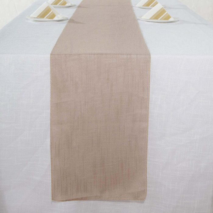 Beige table runner on a white tablecloth with decorative plates.