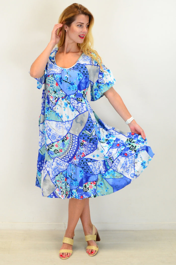 Orientique Kintsugi Tunic Dress displayed on a hanger, showcasing its elegant design and flowing fabric.