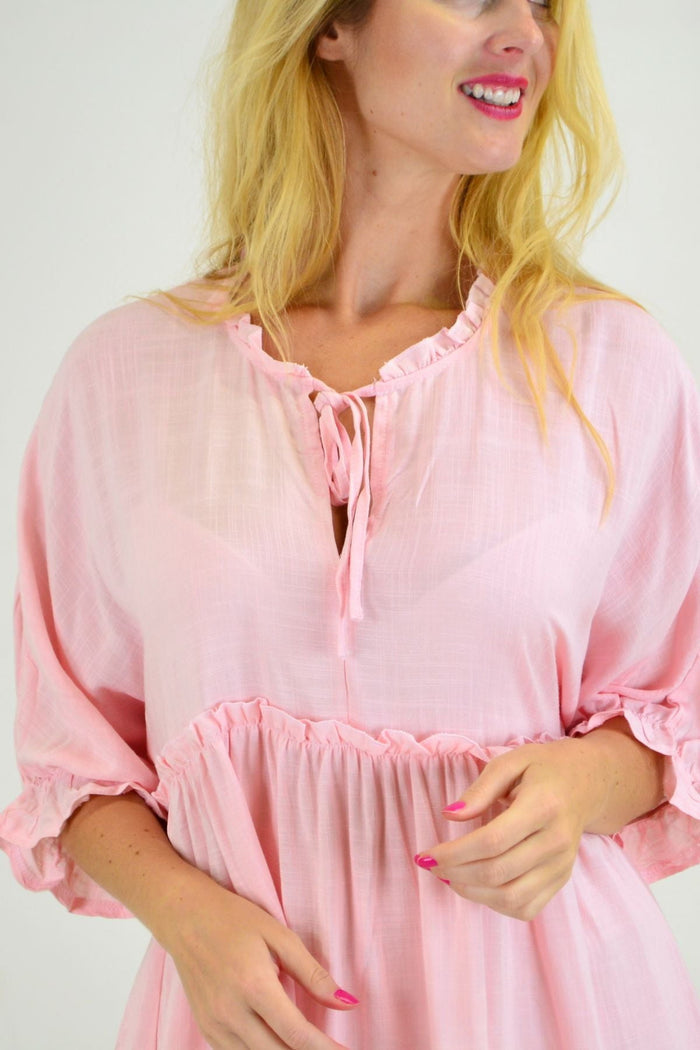 Powder pink relaxed fit tunic blouse from Hourglass, showcasing a casual, flowy design with long sleeves and a round neckline.