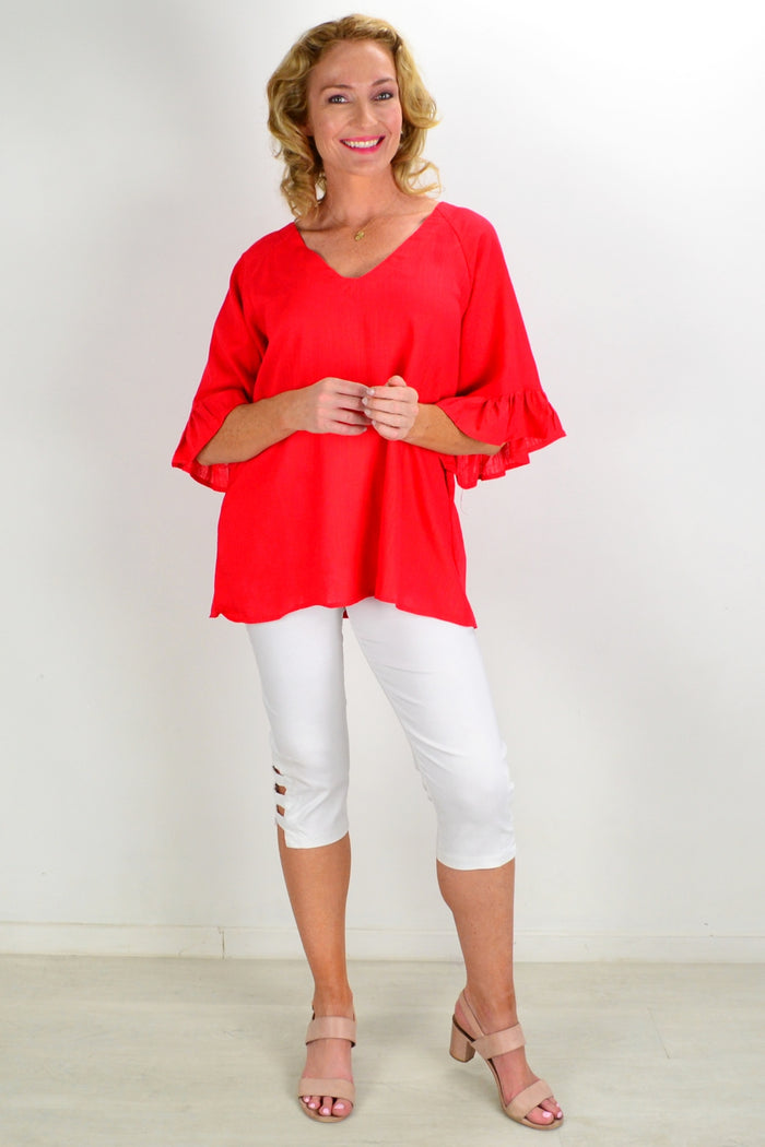 Red Razzle Dazel ruffle sleeve tunic top by Hourglass, featuring vibrant color and stylish ruffle details on the sleeves.
