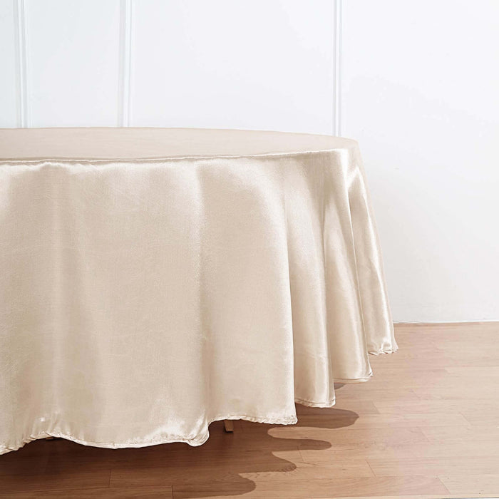 Beige round tablecloth on a wooden table.