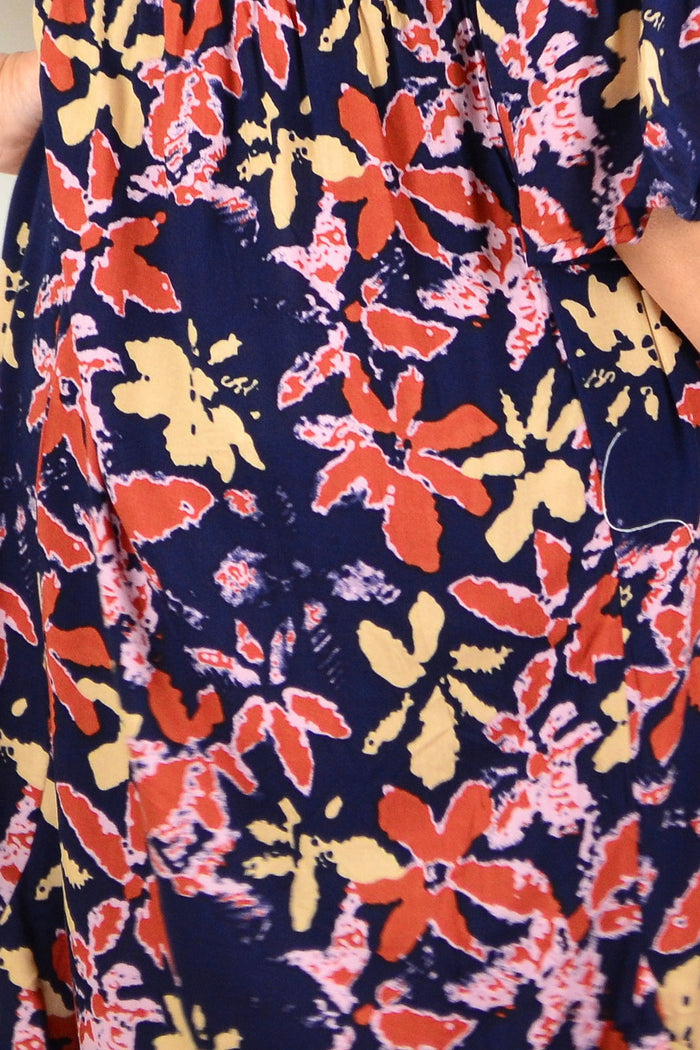 Hourglass Winter Leaves Midi Tunic Dress displayed on a hanger, featuring a floral leaf pattern and a comfortable, flowing design.
