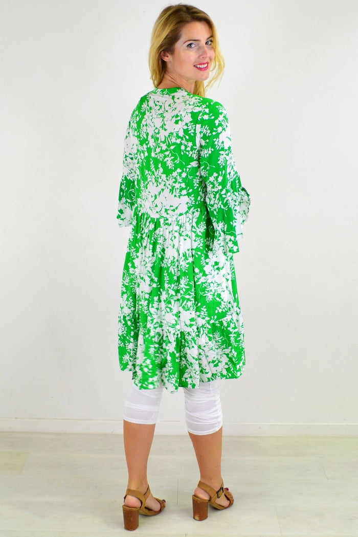 Apple green Willow Tree sweet citrus frill sleeve tunic dress hanging on a hanger with ruffle details and lightweight fabric.
