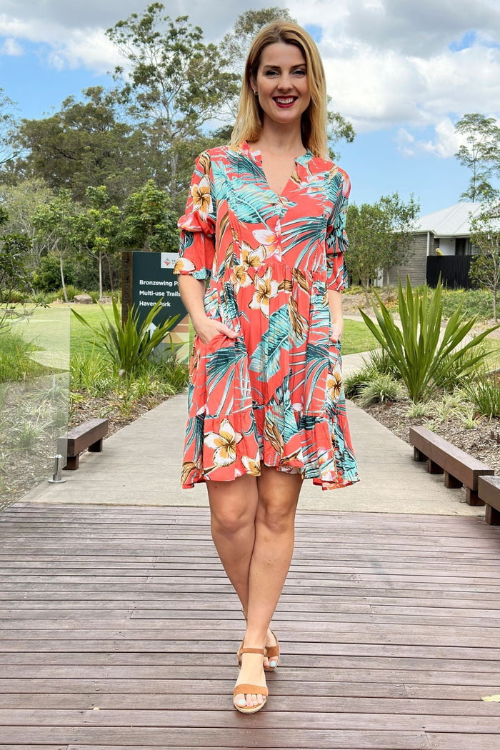 Apricot Sun Goddess Boho Tunic dress by I Love Tunics, featuring flowy fabric and bohemian style, displayed hanging against a neutral background.