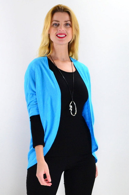 Freez Aqua Mini Shrug Cardigan worn over a tunic, featuring short sleeves and lightweight fabric in a vibrant aqua color.
