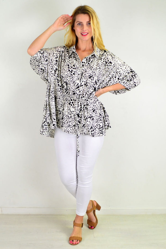 Black giraffe print relaxed fit tunic blouse by Hourglass, loose black and white top with stylish animal print design.