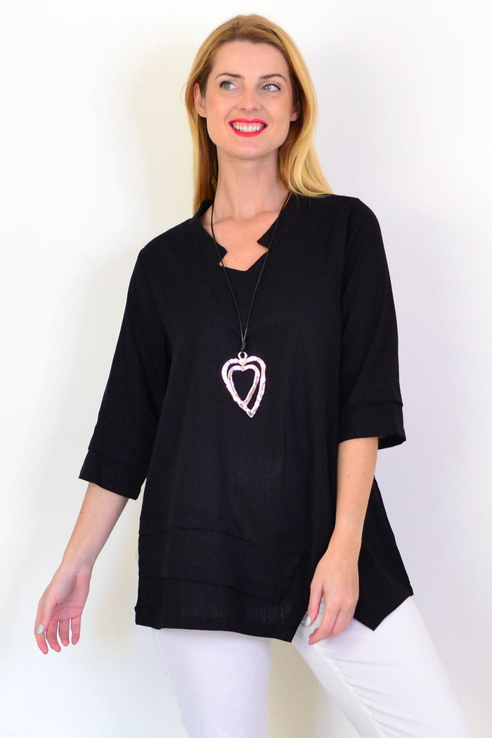Black linen blend tunic top by Hourglass, featuring a relaxed fit and simple design, shown on a model in a casual setting.