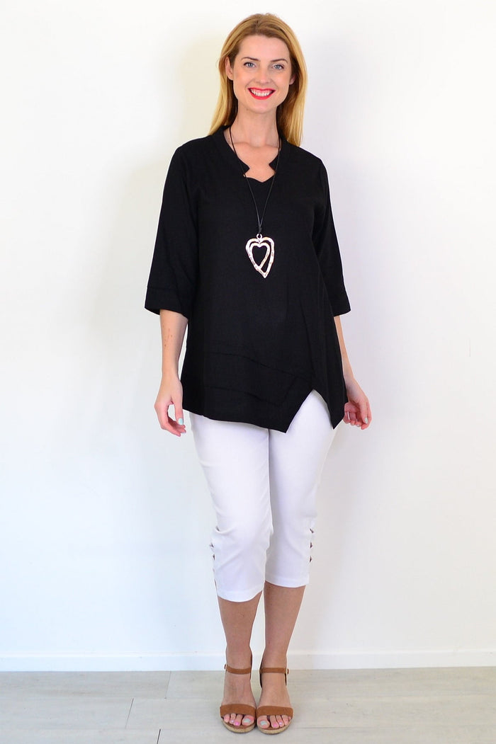 Black linen blend tunic top by Hourglass, featuring a relaxed fit and subtle texture, displayed on a mannequin.