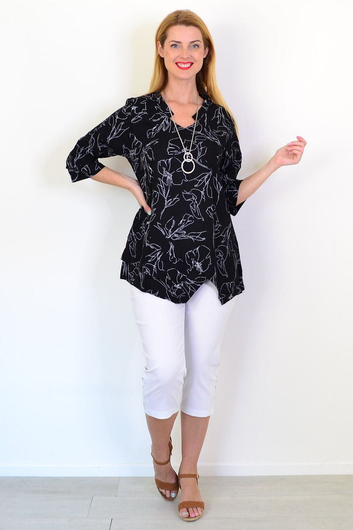 Black and white floral linen blend tunic top by Ruby Rain, featuring a relaxed fit and long sleeves.