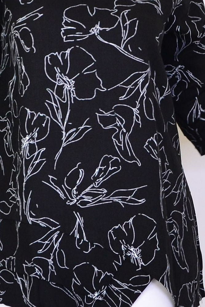 Black and white floral linen blend tunic top by Ruby Rain, featuring a relaxed fit and intricate floral pattern.