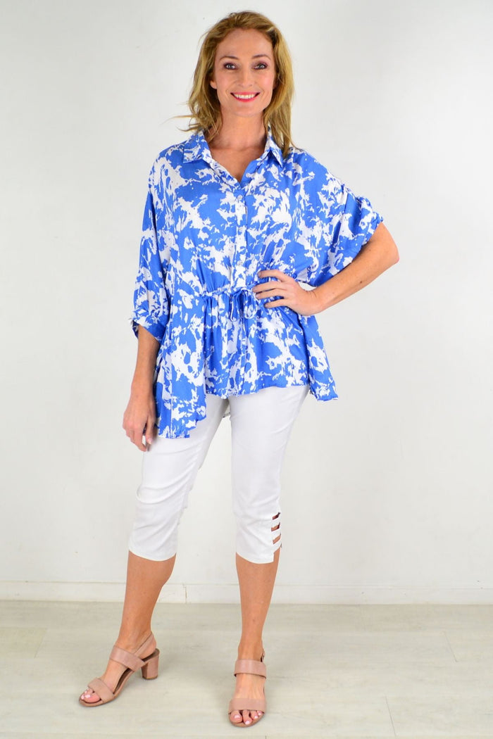 Blue Hourglass Follow Me Relaxed Fit Tunic Blouse with long sleeves and a casual, flowing design, shown on a hanger.