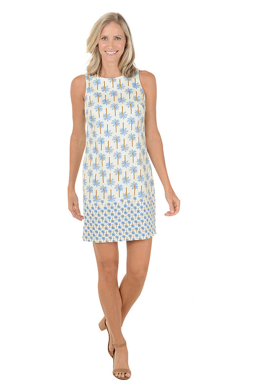 Woman wearing a sleeveless dress with a palm tree pattern on a white background