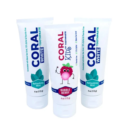 Three tubes of Coral White toothpaste on a white background