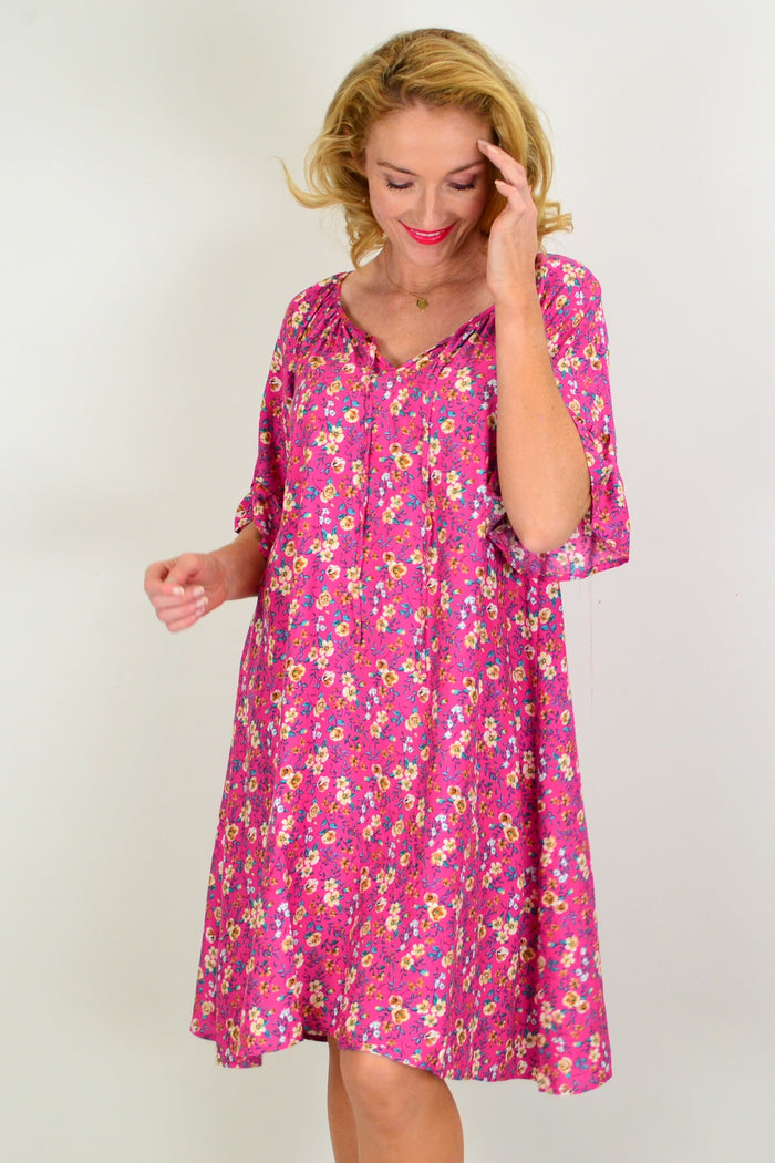 Hourglass Cupid's Corner shift tunic dress hanging on a wooden hanger, featuring a relaxed fit and soft fabric for casual wear.