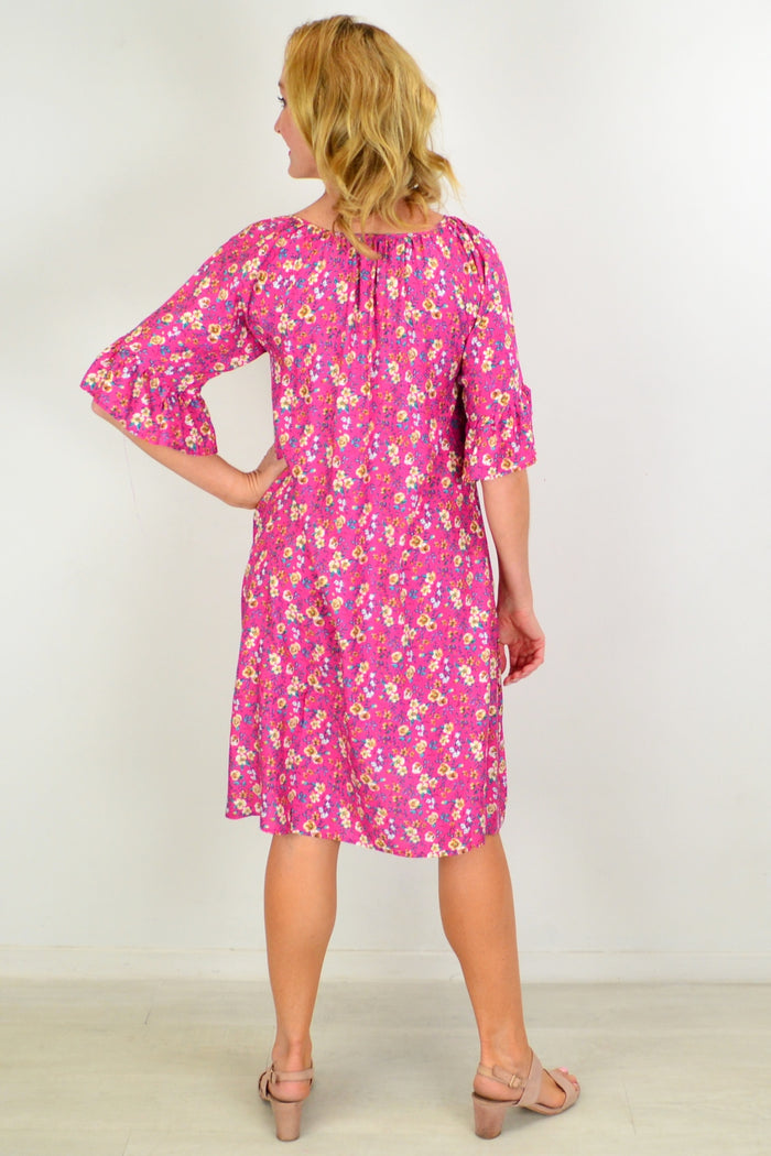 Hourglass Cupid's Corner shift tunic dress hanging on a hanger, featuring a relaxed fit and subtle detailing.