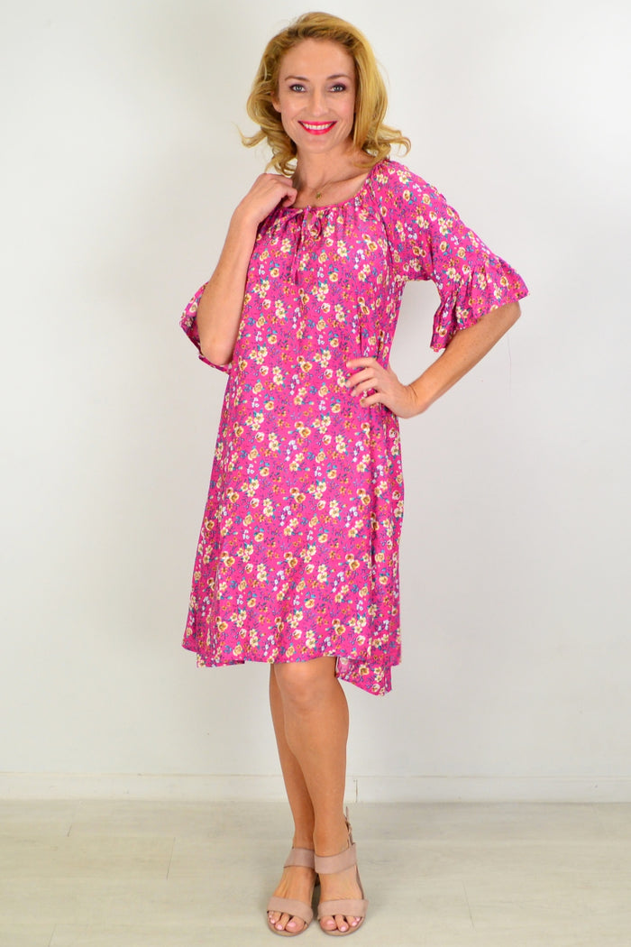 Hourglass Cupid's Corner shift tunic dress hanging on a hanger, showcasing its relaxed fit and soft fabric in neutral tones.