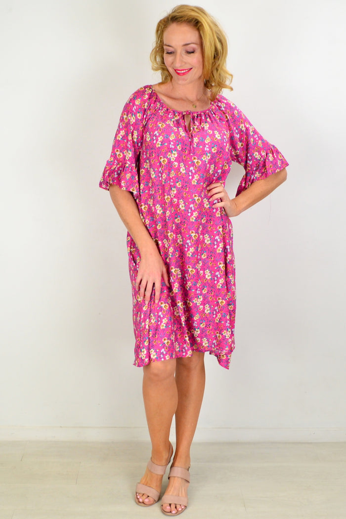 Hourglass Cupid's Corner shift tunic dress hanging on a wooden hanger, showcasing its relaxed fit and stylish design.