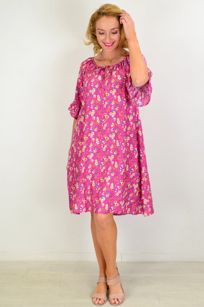 Hourglass Cupid's Corner shift tunic dress displayed on a hanger with a flowing, lightweight fabric in a soft pastel color.