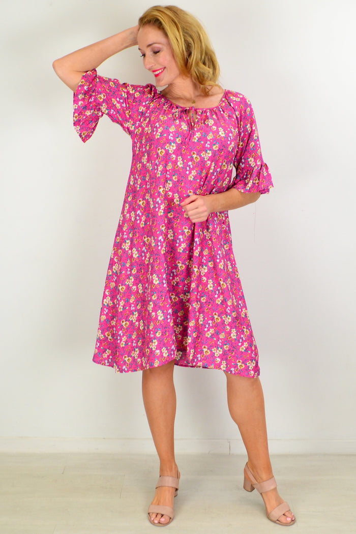 Hourglass Cupid's Corner shift tunic dress hanging on a wooden hanger with a soft, flowing fabric and a relaxed fit.