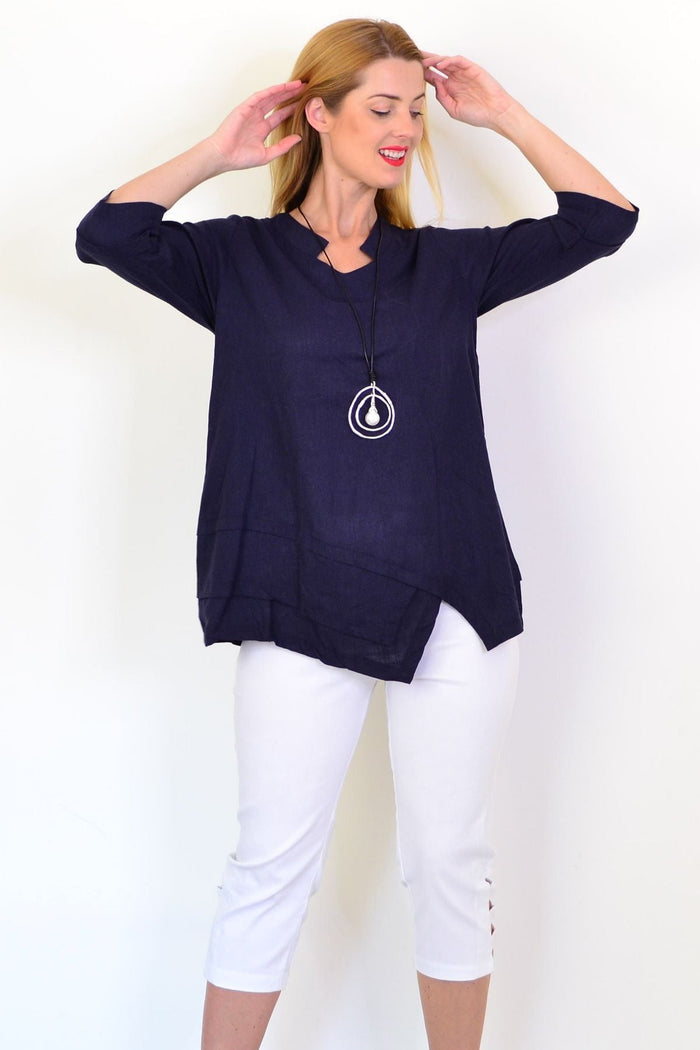 Hourglass denim linen blend tunic top displayed on a hanger, featuring a relaxed fit, sleeveless design, and casual style.