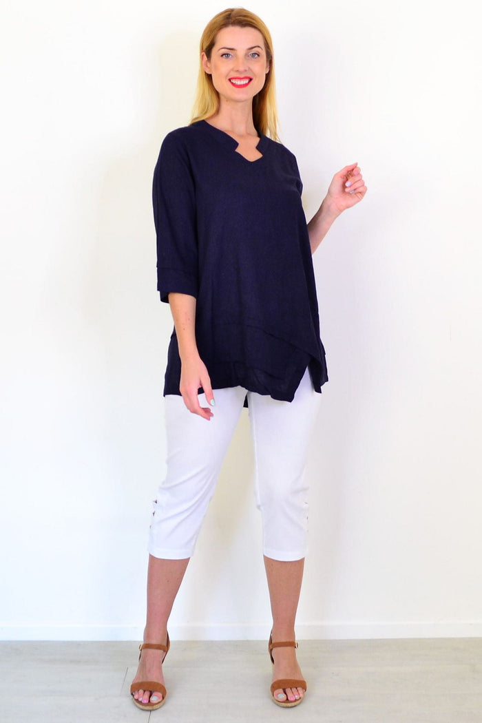 Hourglass denim linen blend tunic top displayed on a hanger, featuring a relaxed fit and casual style.