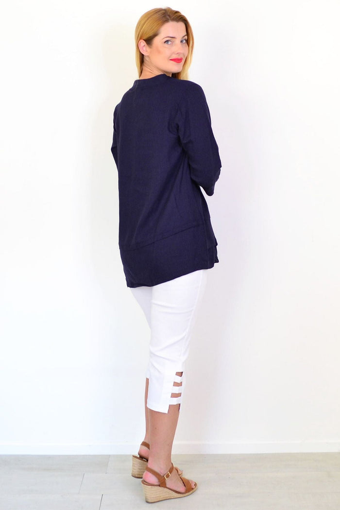Hourglass denim linen blend tunic top displayed on a hanger, showcasing its relaxed fit and casual style.