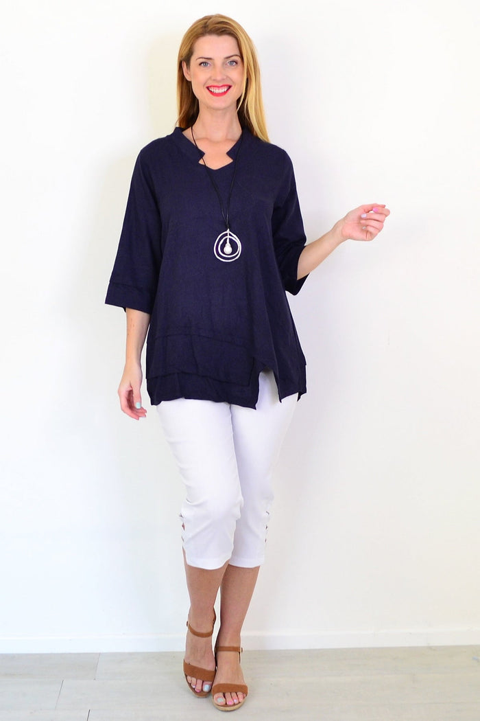 Hourglass denim linen blend tunic top displayed on a hanger with a relaxed fit and casual style.