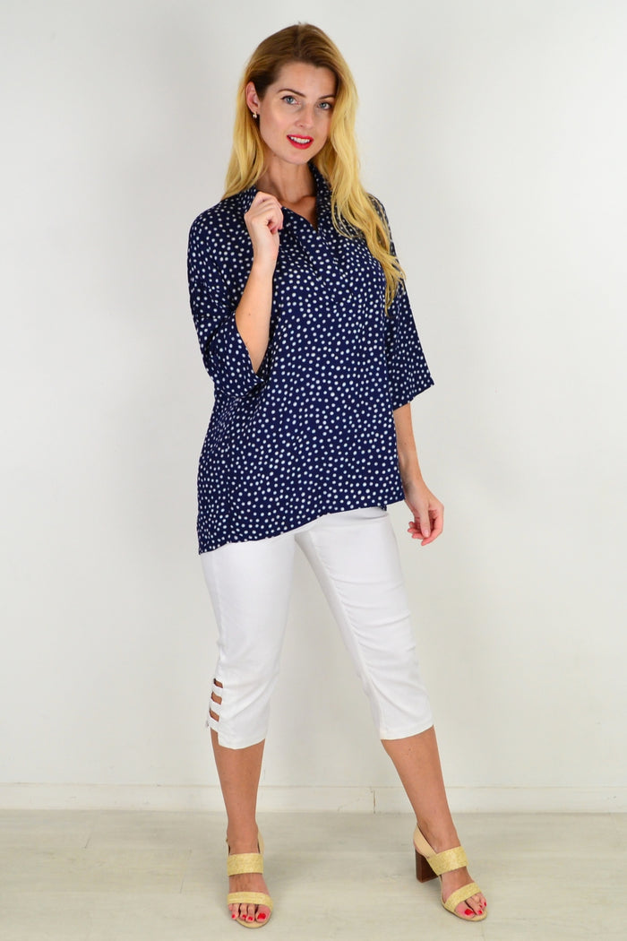 Stylus Dot in a Dot Tunic Top displayed on a hanger, showcasing its patterned fabric and relaxed fit.