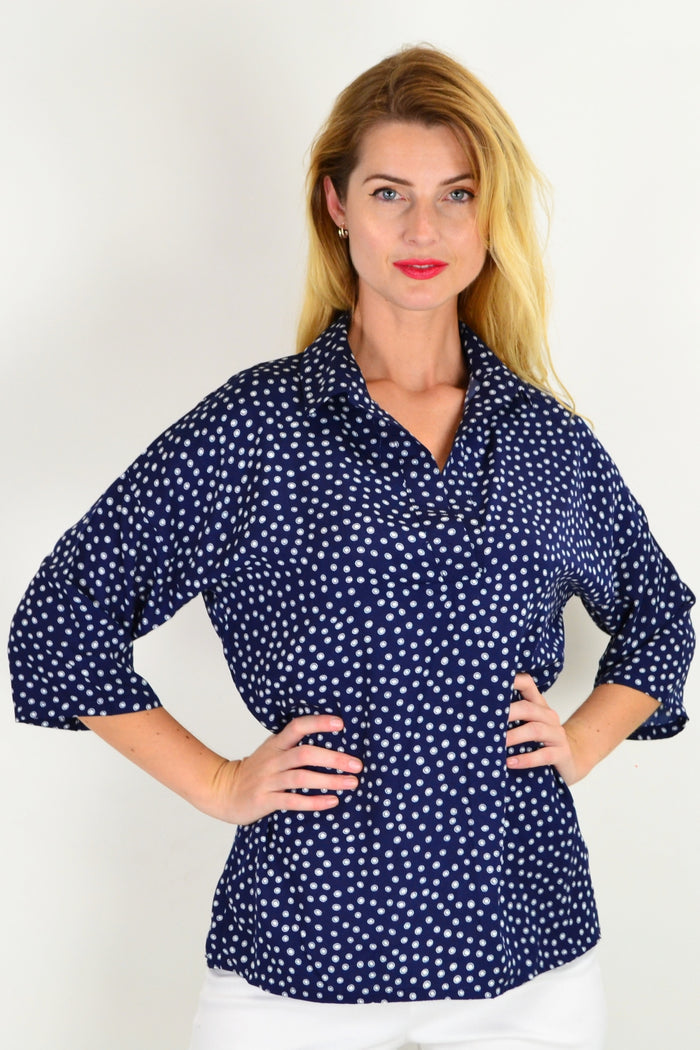 Stylius Dot in a Dot tunic top with a relaxed fit, featuring a black and white polka dot pattern and long sleeves.
