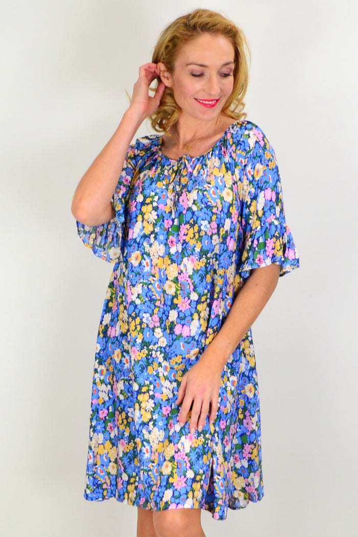 Hourglass Fairy Garden shift tunic dress, lightweight fabric with floral print, casual boho style, displayed on a hanger.
