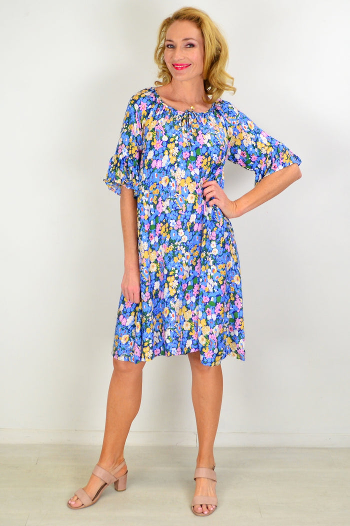 Hourglass Fairy Garden shift tunic dress displayed on a hanger, featuring floral patterns and lightweight fabric for casual wear.
