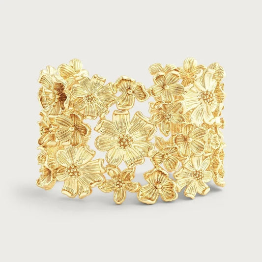 Wildflower‑inspired wide cuff bracelet  with sculpted gold-tone flowers in an open cuff design