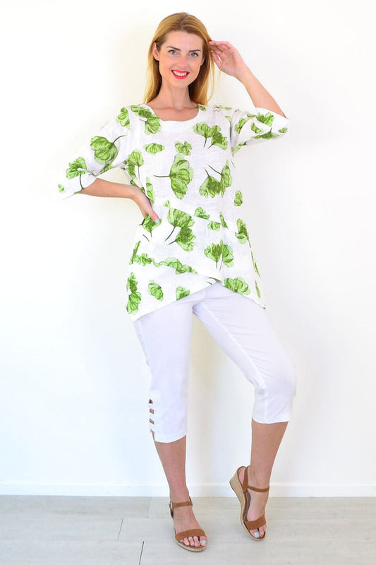 Green flower linen blend tunic top by Ruby Rain, featuring a relaxed fit and floral print, shown on a hanger or model.