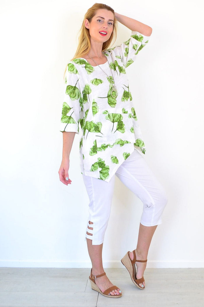 Green flower linen blend tunic top by Ruby Rain, featuring a relaxed fit and floral print, displayed on a hanger.