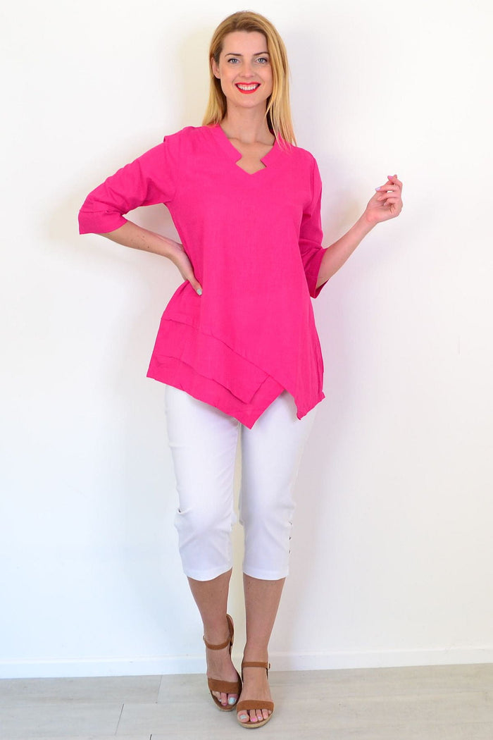 Hot pink linen blend tunic top by Hourglass, featuring a relaxed fit and lightweight fabric, displayed on a hanger.