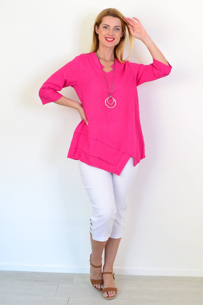 Hot pink linen blend tunic top from Hourglass, featuring a relaxed fit and lightweight fabric, displayed on a hanger.