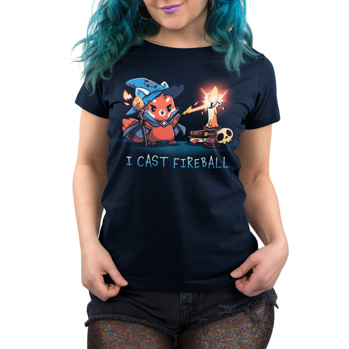 Premium Cotton T-shirt_TeeTurtle I Cast Fireball navy blue t-shirt featuring a fox in a tabletop game wizard outfit with a staff who casts a fireball spell towards a candle, with the text "I CAST FIREBALL" below. A stack of books and a skull are in the background.