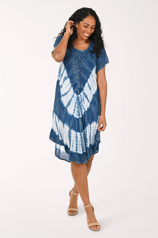 Woman wearing a blue and white tie-dye dress on a white background