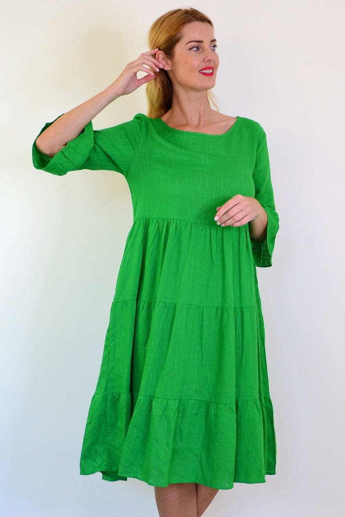 Jade green Hourglass shift tunic dress hanging on a wooden hanger, featuring a relaxed fit and simple neckline.
