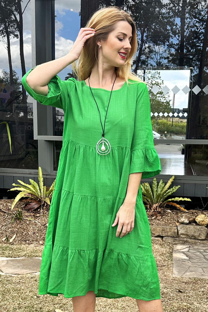 Jade green Hourglass shift tunic dress hanging on a hanger, showcasing its relaxed fit and smooth fabric.