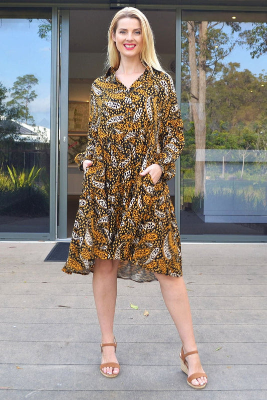 Jasmine Paisley Boho Australia tunic dress with flowing fabric and paisley pattern, displayed hanging on a wooden hanger.