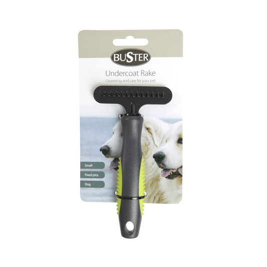 White background with a small black BUSTER Undercoat Rake Brush with fixed pins and green grips on the handle attached to a cardboard backing.