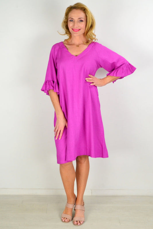 Magenta Hourglass three shift tunic dress hanging on a mannequin, featuring a relaxed fit and simple neckline.