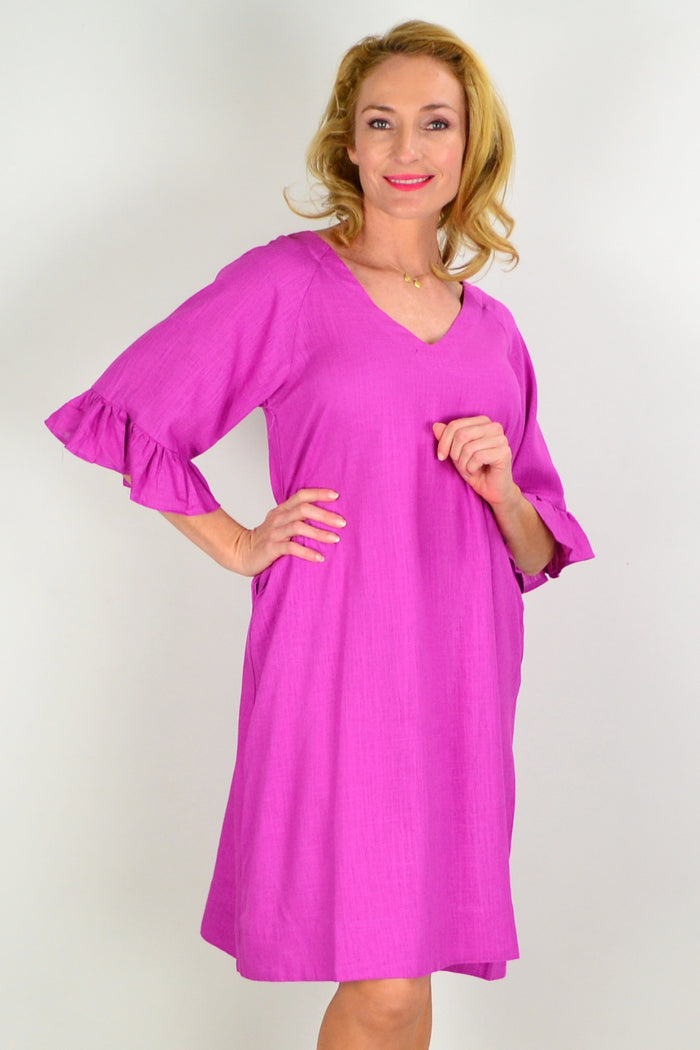 Magenta Hourglass three-shift tunic dress with long sleeves and a relaxed fit, displayed on a hanger.