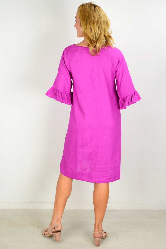 Magenta three-shift tunic dress by Hourglass, featuring a flowing silhouette and stylish design, displayed on a model.