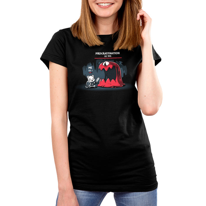 Premium Cotton T-shirt_TeeTurtle black Me Vs. Procrastination featuring a cat knight labeled "ME LV. 1" standing nervously in front of a giant red monster labeled "PROCRASTINATION LV. 342" in a dark, cavernous setting.